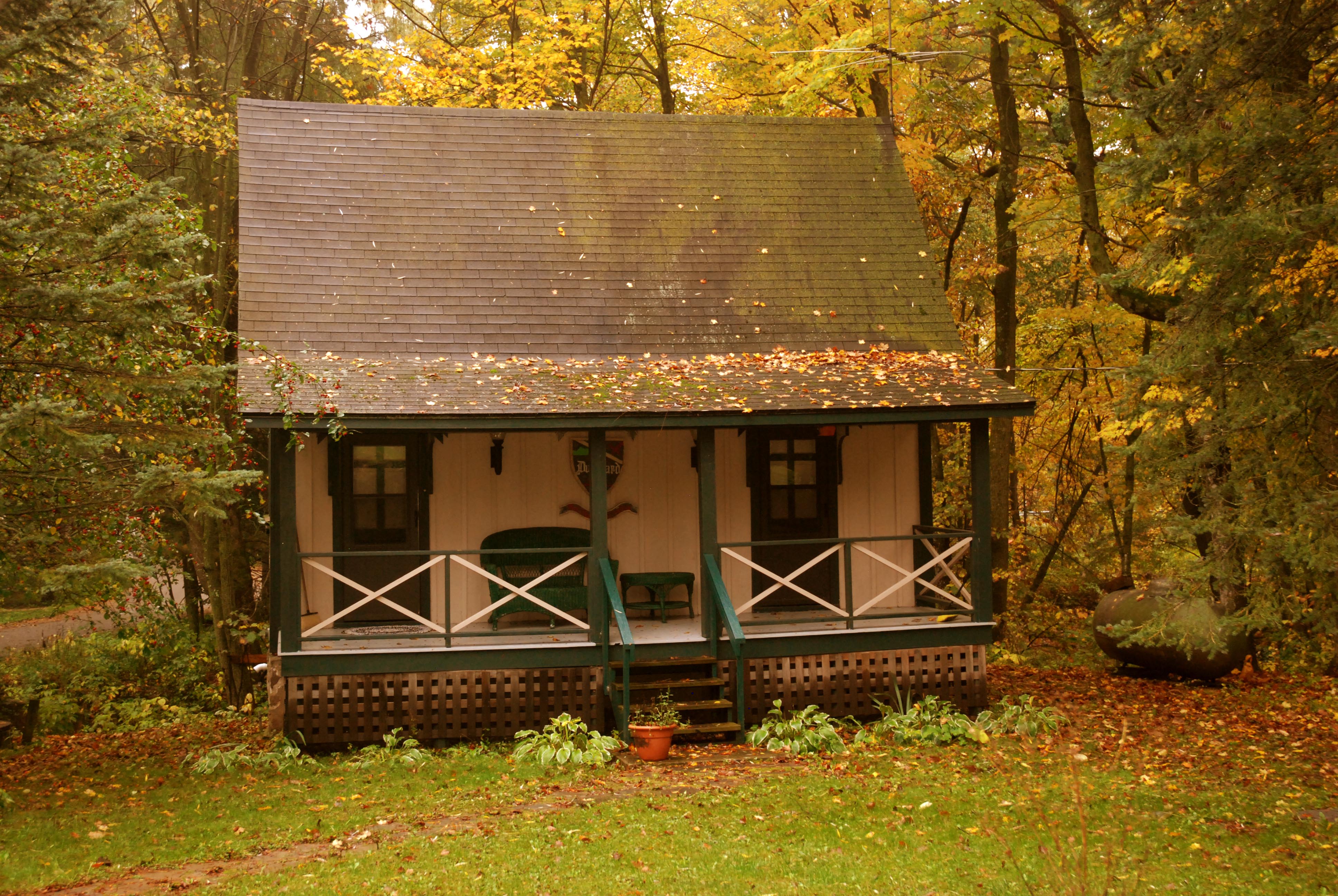 Artist's Cottage exterior with front porch in autumn